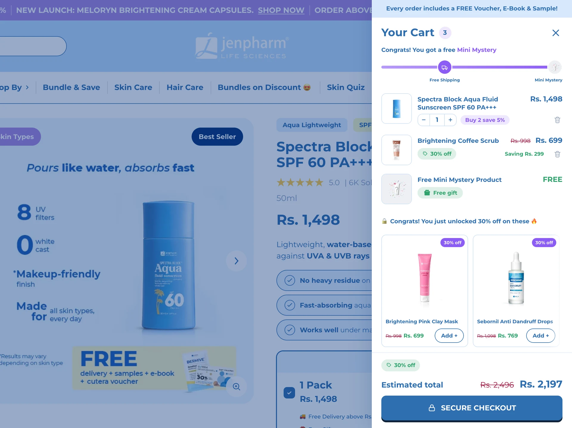 Jenpharm's cart drawer over a product page, with the free Mini Mystery unlocked, a coffee scrub added at 30% off and the total down to Rs 2,197